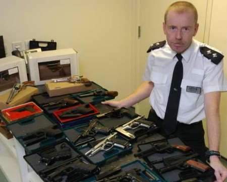 Police inspector Matt Arnold with weapons seized in the raids. Picture: MATT WALKER