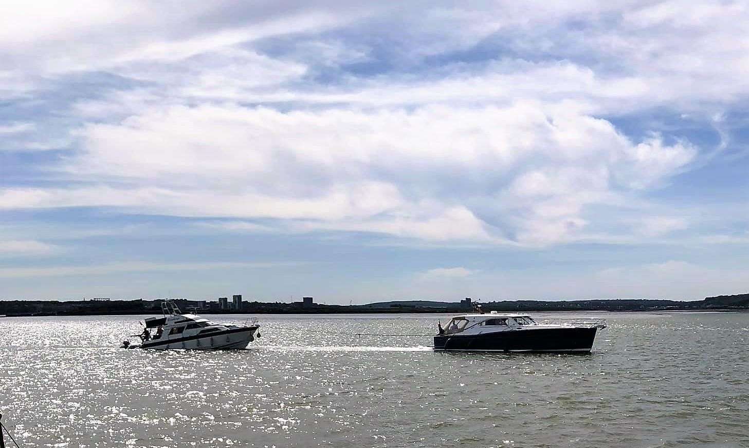 The sinking boat under tow in the Medway