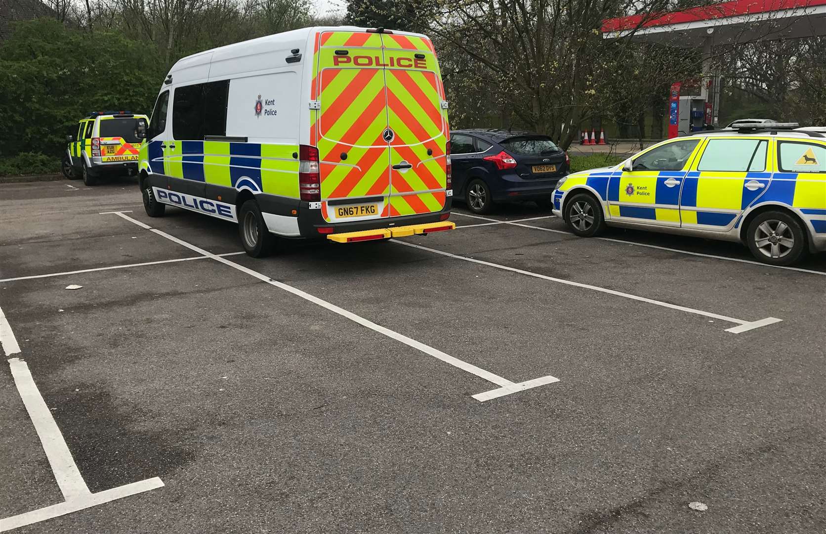 Police at the Esso Garage, near the Brotherhood Wood caravan site on the A2 in Dunkirk