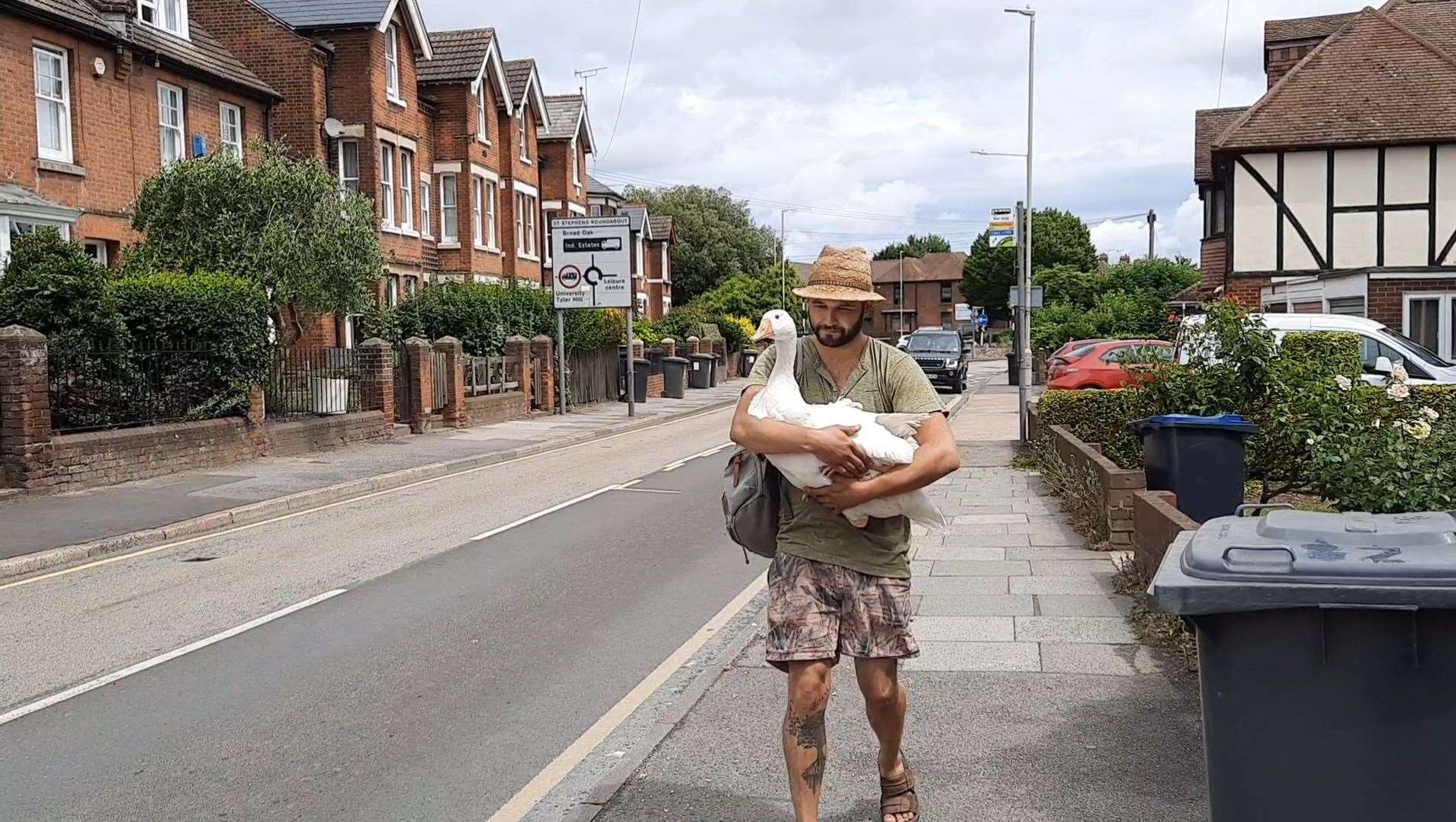 James holding Phoenix as they walk along St Stephen's Road in Canterbury