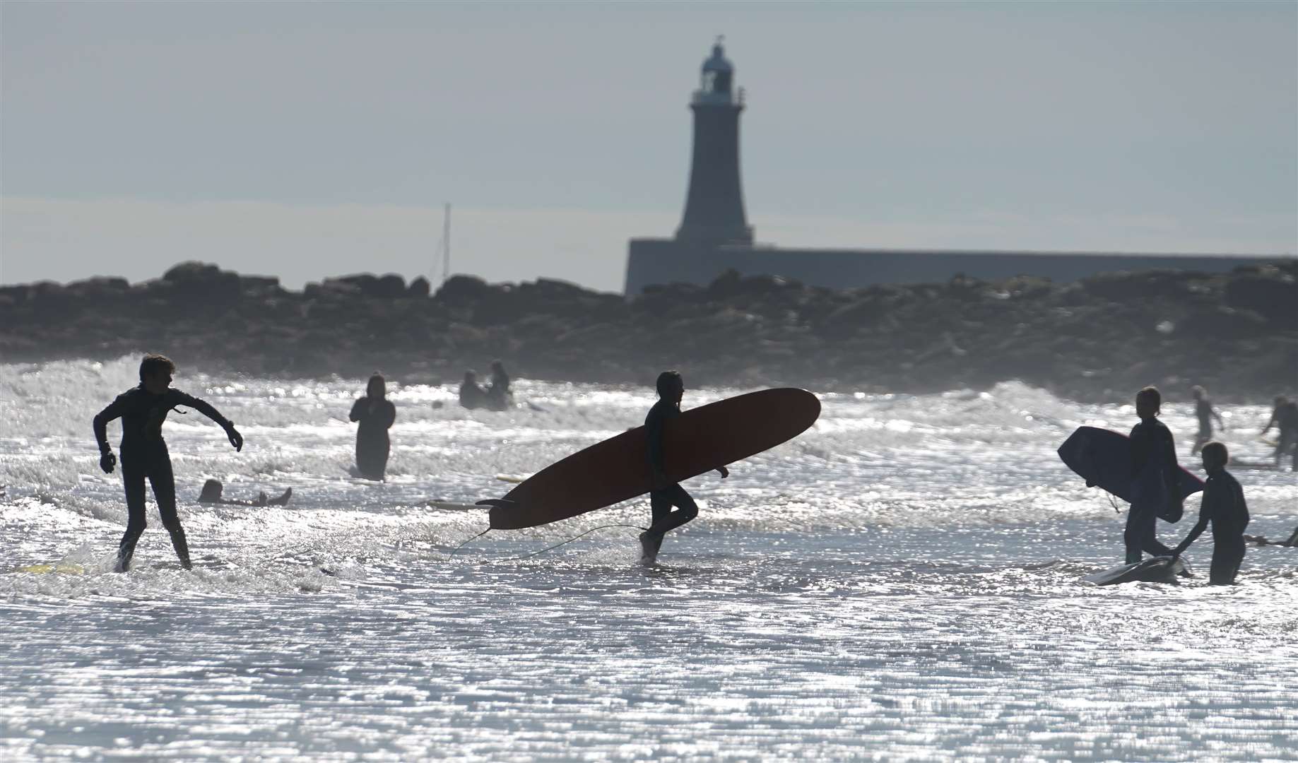 Temperatures were a far cry from the highs enjoyed at the start of the month, but these beachgoers were undeterred (Owen Humphreys/PA)