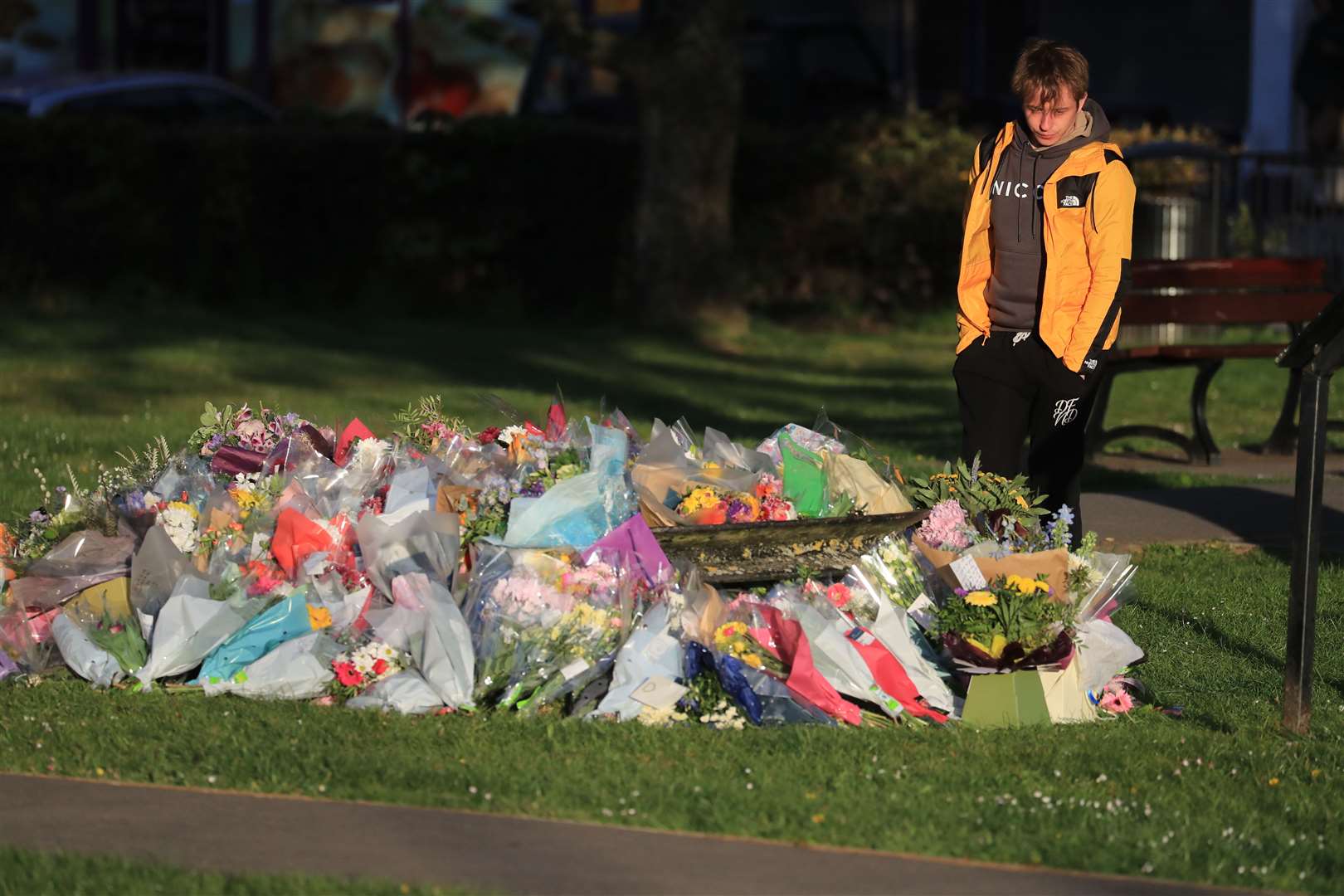 Patrick James, the son of PCSO Julia James, looks at floral tributes left near her family home (Gareth Fuller/PA)