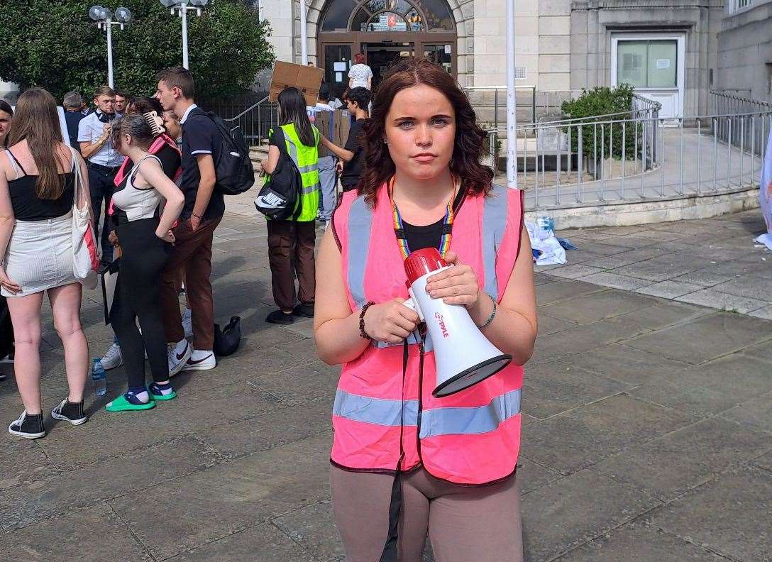 Macy Oshea, 17, a member of GYG youth group, protests the cuts outside County Hall