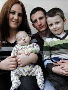 Michelle Hayman with her son George, partner Jarno and other son William at home in Shipman Avenue, Canterbury. George has just come out of hospital after 10 weeks of fighting meningitis.