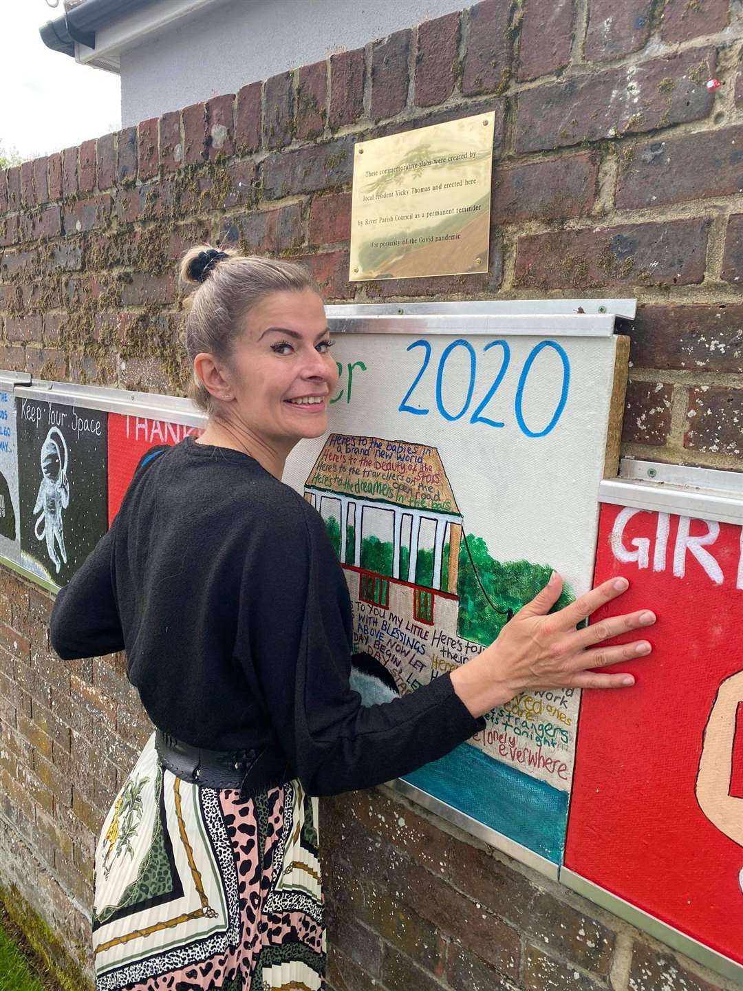 Vicky Thomas with the plaque to commemorate the opening of her display of painted slabs