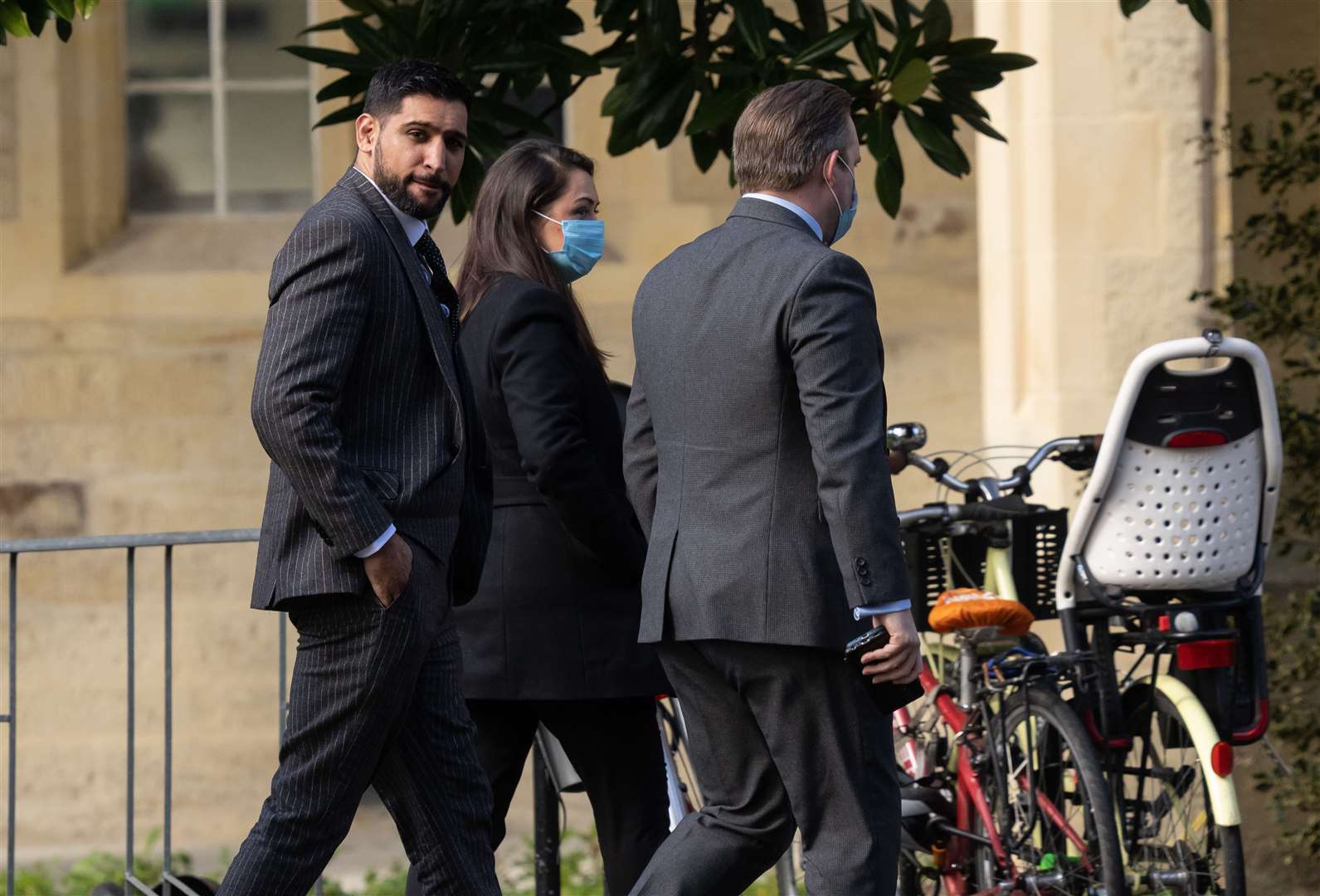 Former world boxing champion Amir Khan, left, arrives at Snaresbrook Crown Court (Jeff Moore/PA)