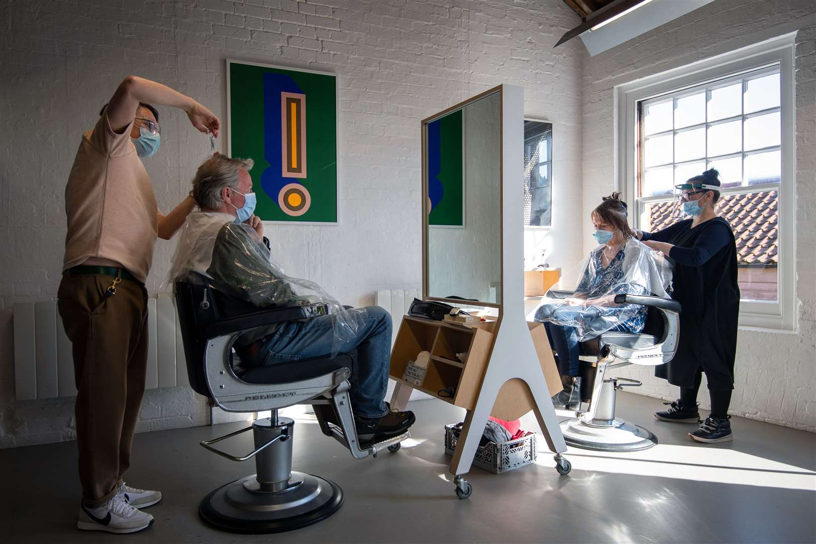 Customers have their hair cut at the reopening of Flint Hair in Norwich, Norfolk (Joe Giddens/PA)