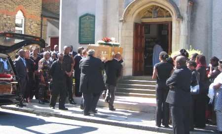 Mourners look on as the coffin is carried into the church. Picture: RUDOLF RICHTER