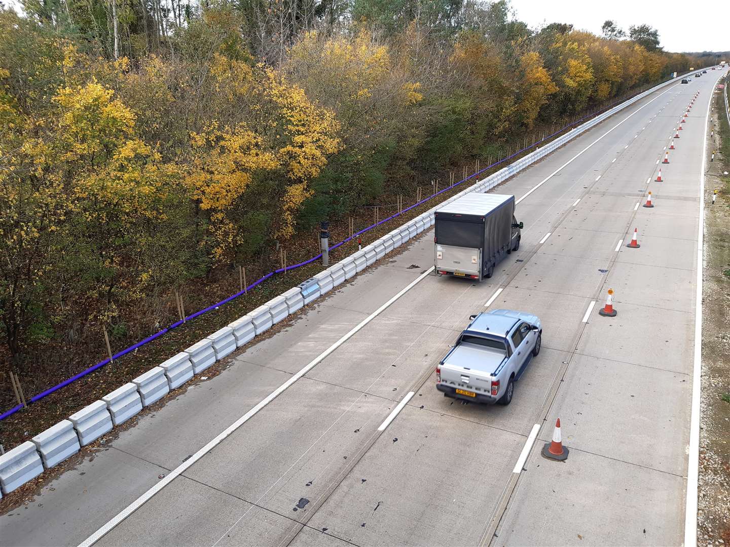 The moveable concrete barrier is being stored on the hard shoulder