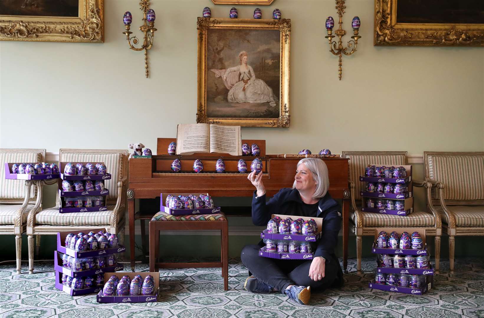 Claire Grant from the National Trust for Scotland with a pile of Easter eggs in the drawing room at the Georgian House in Edinburgh (Andrew Milligan/PA)