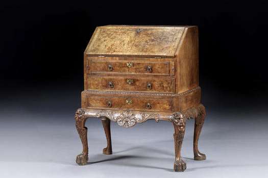 A George II walnut cross-banded and feather-banded bureau which sold for £80,500 inc. premium