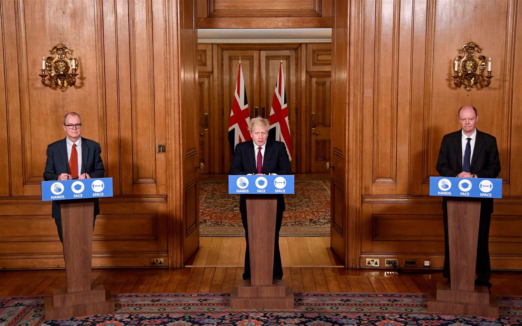 England’s chief scientific adviser Sir Patrick Vallance, left, and chief medical officer Professor Chris Whitty, right, and Prime Minister Boris Johnson (Toby Melville/PA)