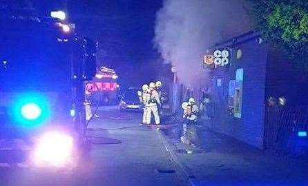 Firefighters enter the Co-op building in Upchurch. Picture: Alan Snellings (9374996)