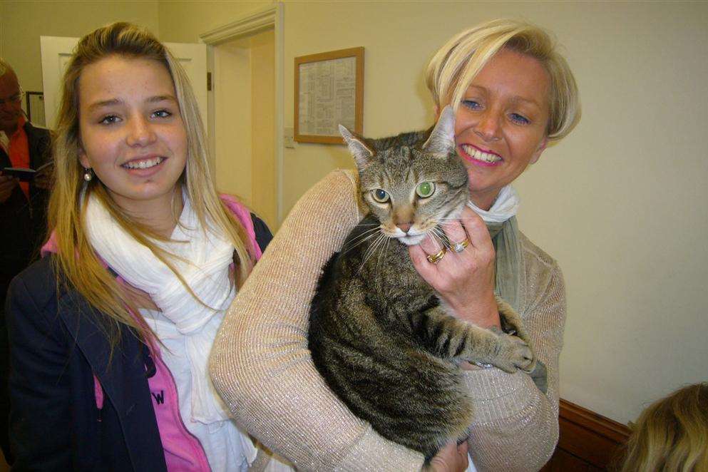 Poussey the cat is reunited with her French owners Charlotte and Sandrine Foehr. Picture: Rosie Blundell