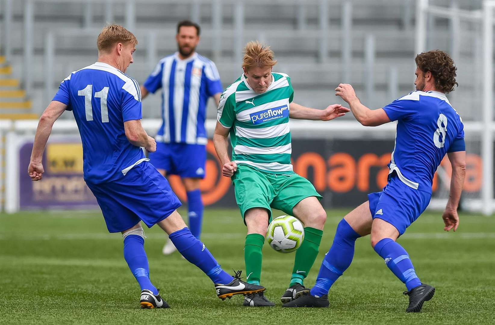 Action from the Kent Veterans Cup final between New Ash Green (green) and Metrogas. Picture: PSP Images