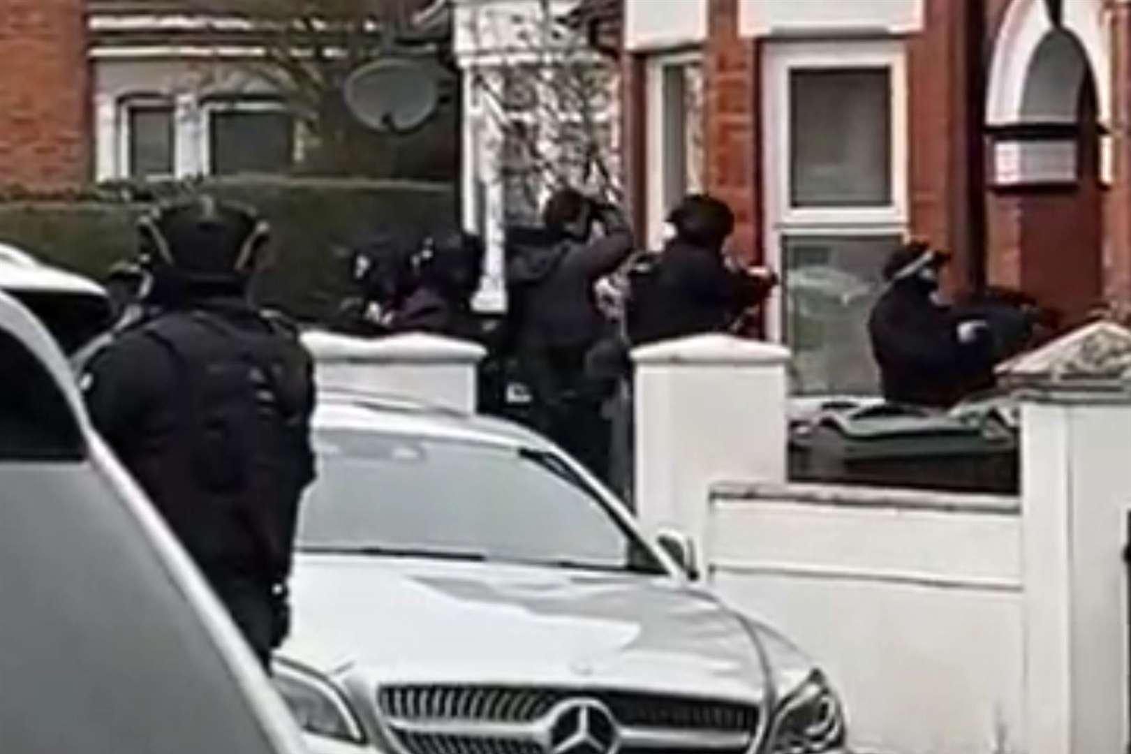 Armed police were seen entering a house in Godinton Road