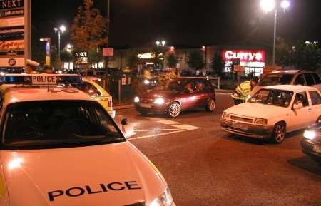 Police in one of the swoops, blocking off car park entrances in Crayford to question drivers who have poured into the area. Picture: PETER BAYLIS