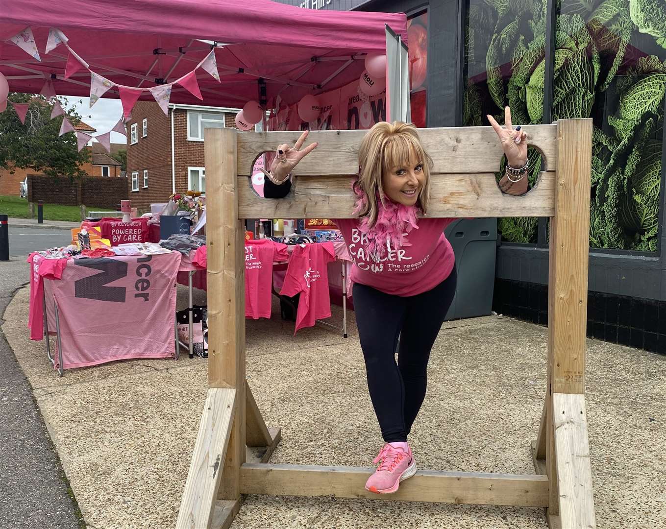 Kerry Banks BEM in the stocks raising awareness for Breast Cancer Month in October