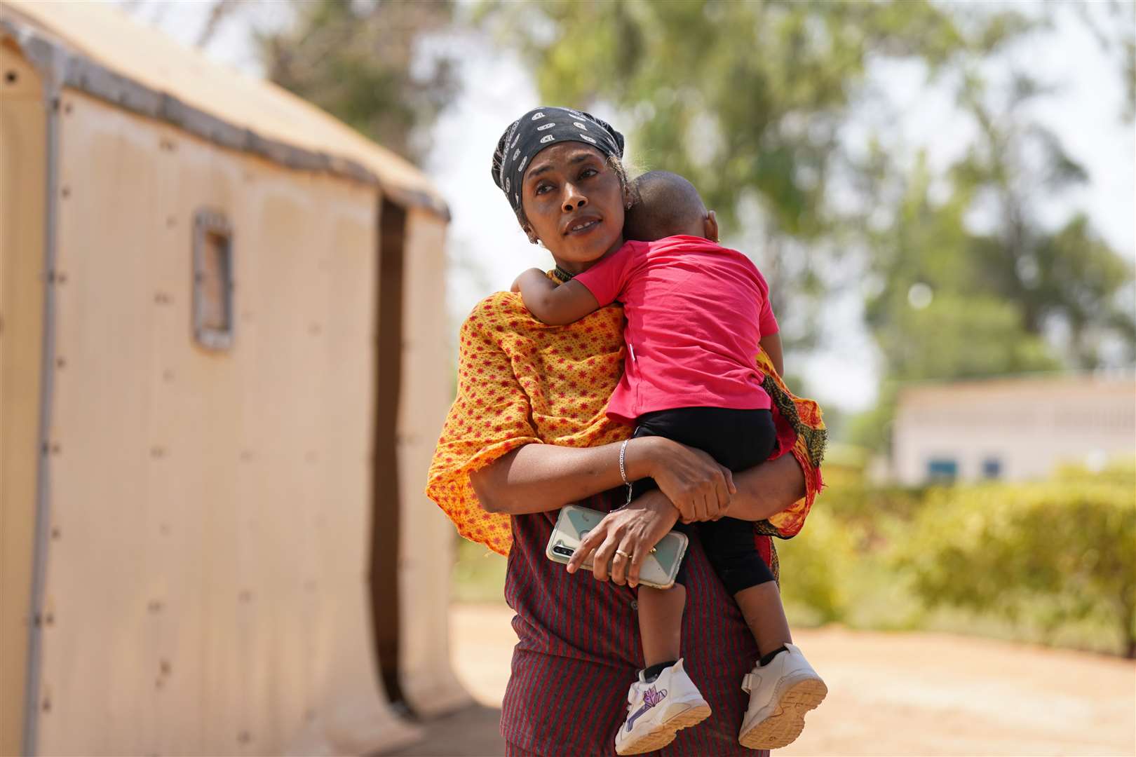 Resident Entsar Tsagai and her 18-month-old daughter Sundus (Victoria Jones/PA)