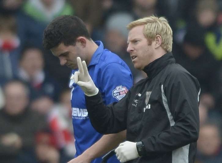 Gills physio Gary Hemens deals with John Egan's injury Picture: Barry Goodwin