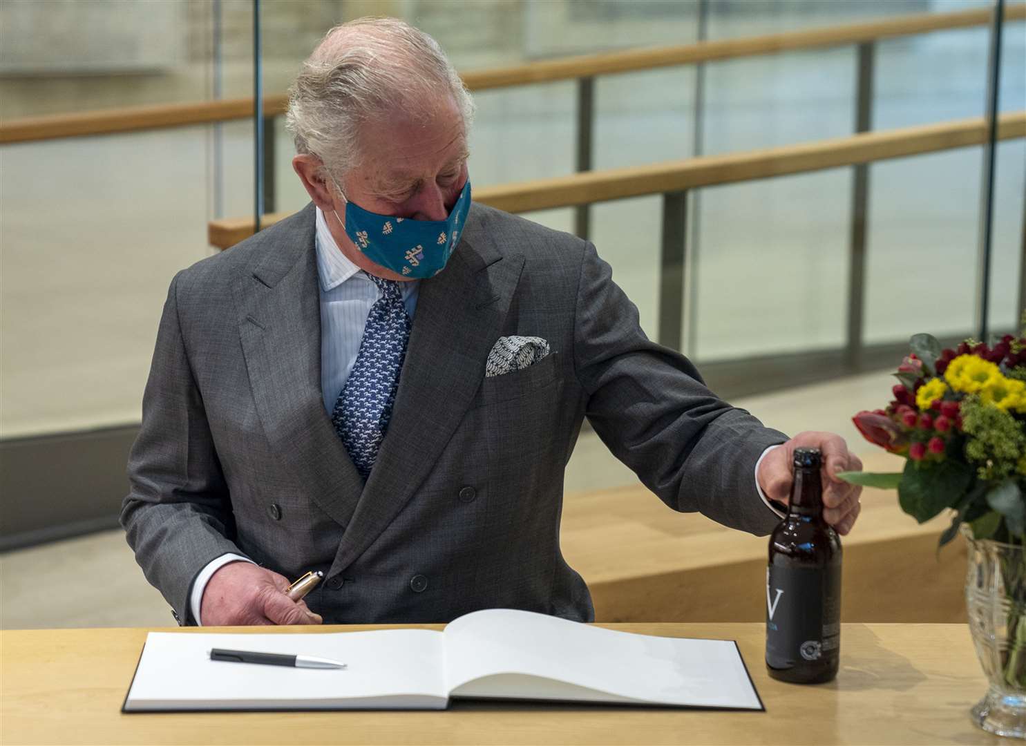 Charles is given a bottle of locally brewed beer (Arthur Edwards/The Sun/PA)