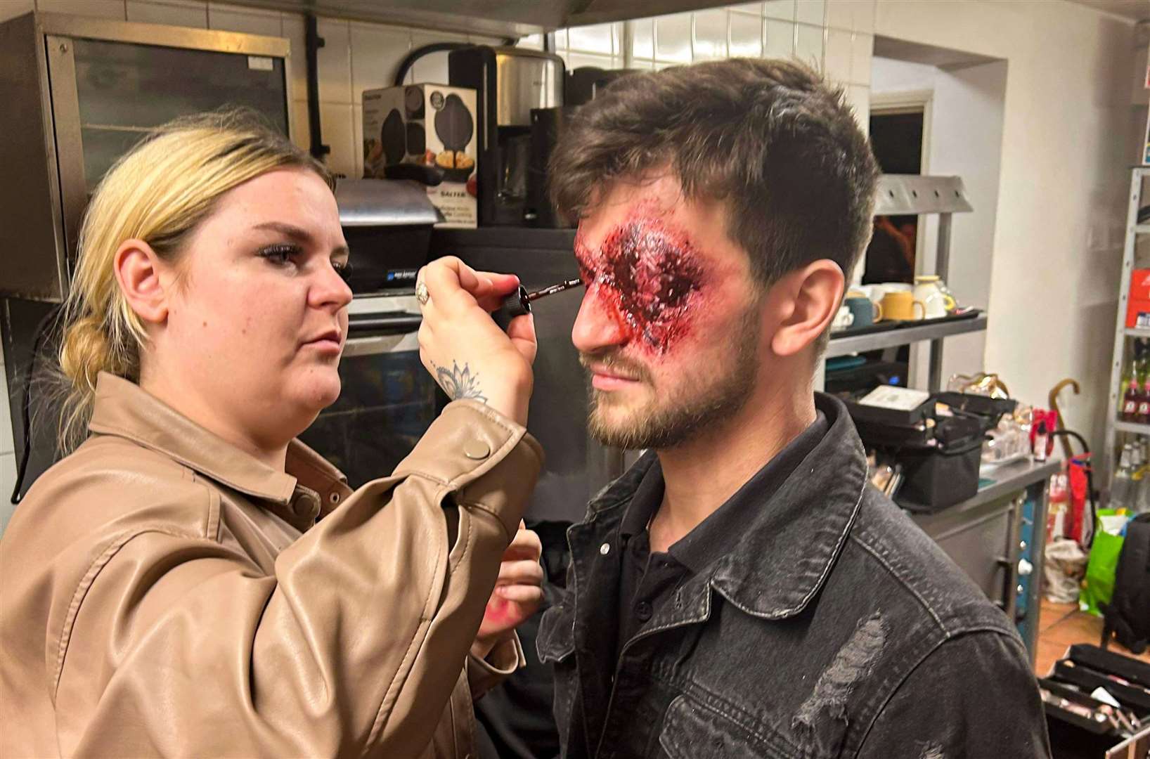 Chloe Burrell applying make-up to William Phillips. Picture: Taylor Williams/WilliamsTPhotography