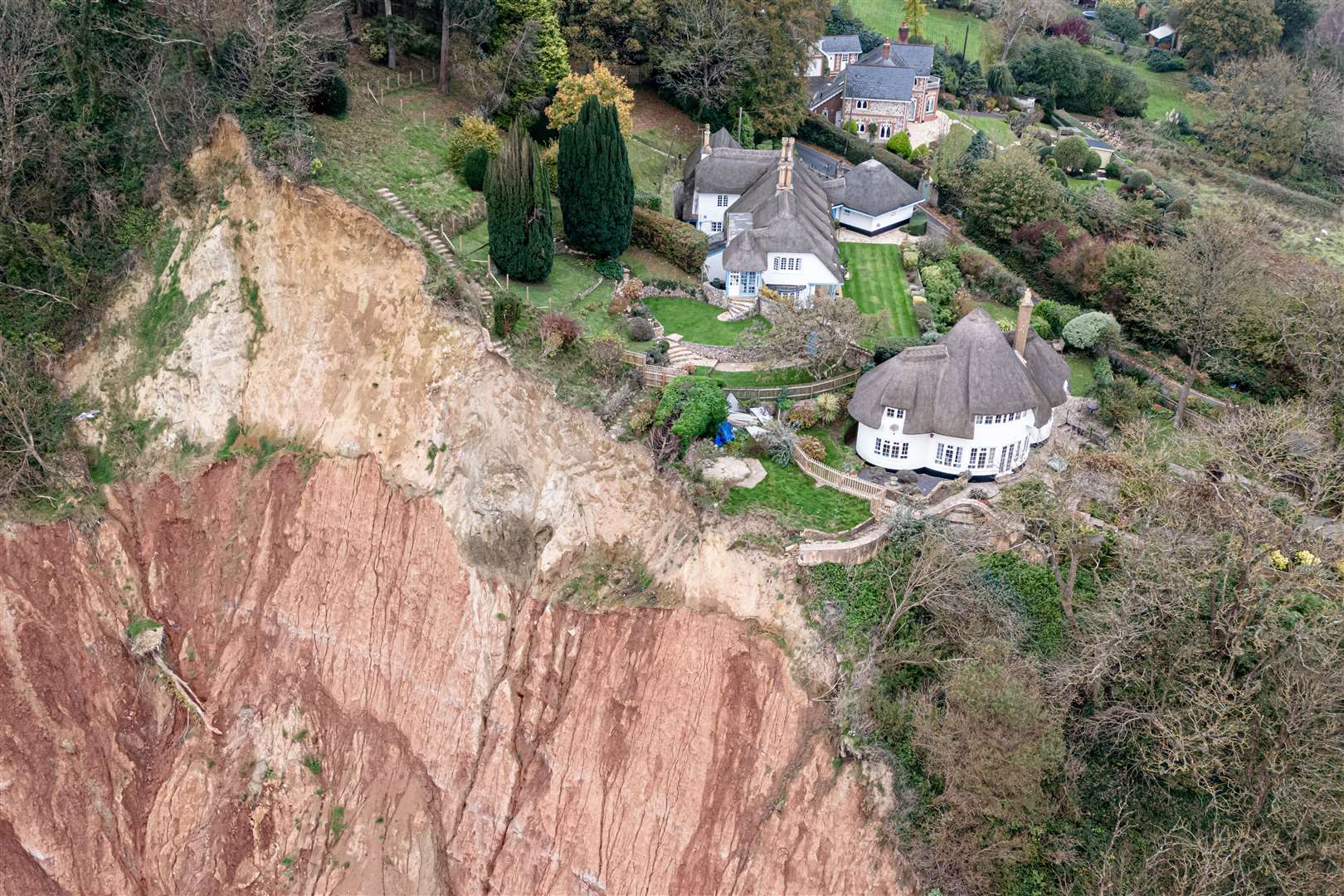 The cottage sits around 40ft from a cliff edge with a 400ft drop, following a small rockfall directly below and a significantly large cliff collapse a few hundred meters away, on a cliff top area between Sidmouth and Ladram Bay (Ben Birchall/PA)