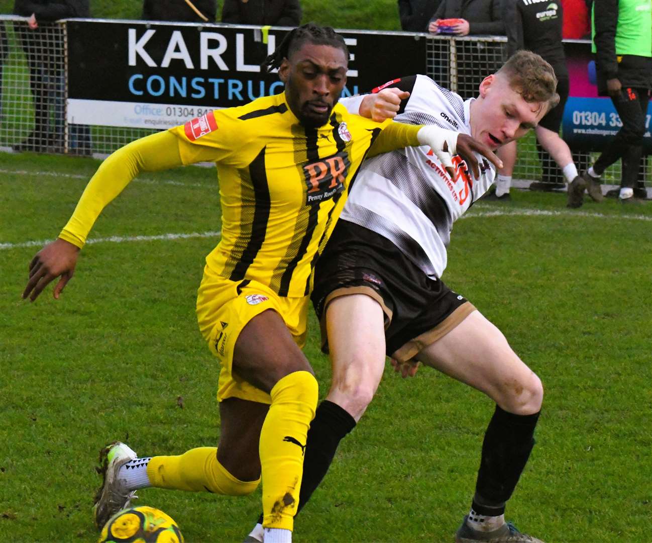 Sheppey's Gil Carvalho does battle with Deal defender Alex Green. Picture: Marc Richards