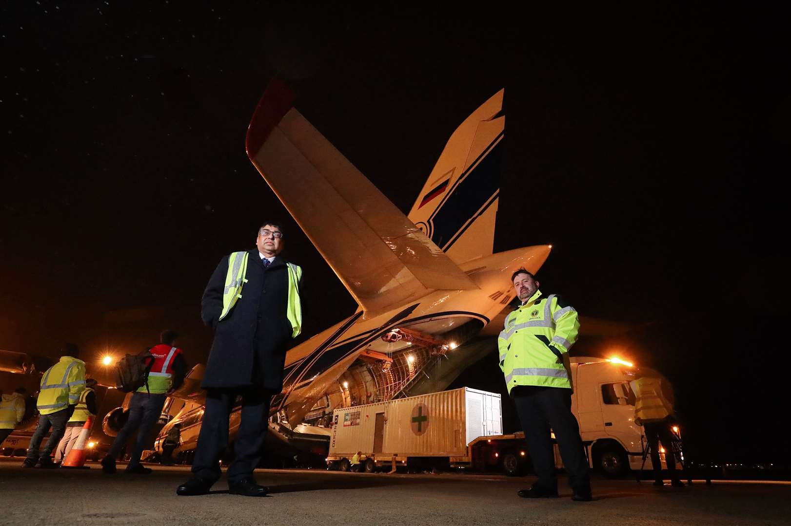 Health Minister Robin Swann, right, and Naresh Chada, deputy chief medical officer, were at the airport as the oxygen generating machines were loaded (Press Eye/PA)