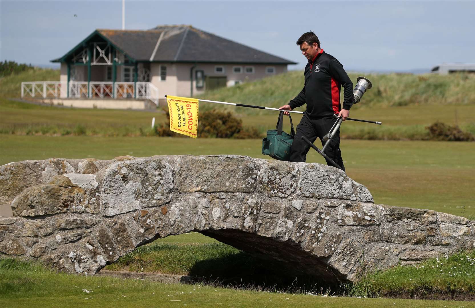 Greenkeeper Simon Connah prepares the Old Course at St Andrews for a return to play as lockdown restrictions ease in Scotland (Andrew Milligan/PA)