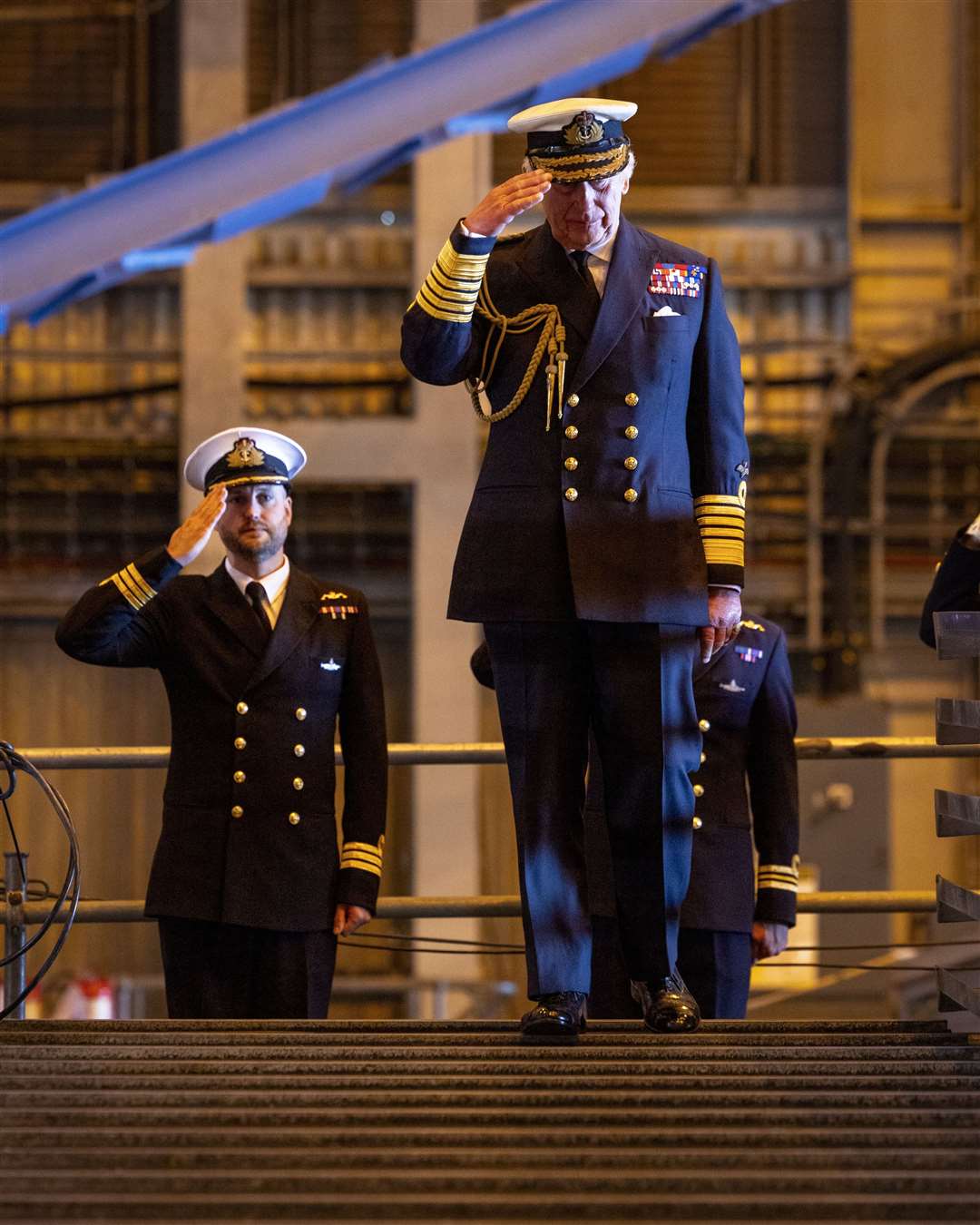 The King and senior submariners salute during his visit to the naval base (LPhot Stuart Dickson/MoD/Crown Copyright/PA)