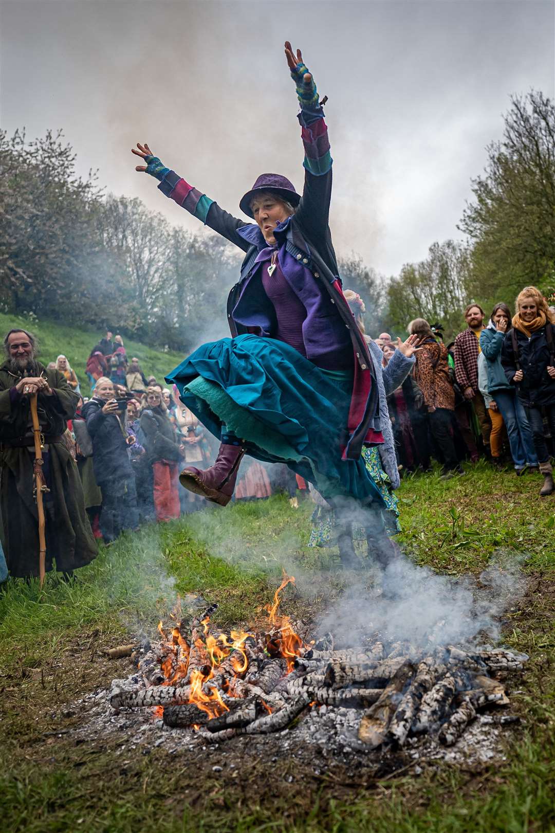 People jump the Beltane bonfire at Chalice Well (Ben Birchall/PA)