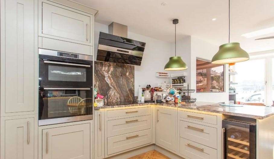 The kitchen is fully fitted with appliances such as an induction hob and wine cooler. Picture: Miles and Barr