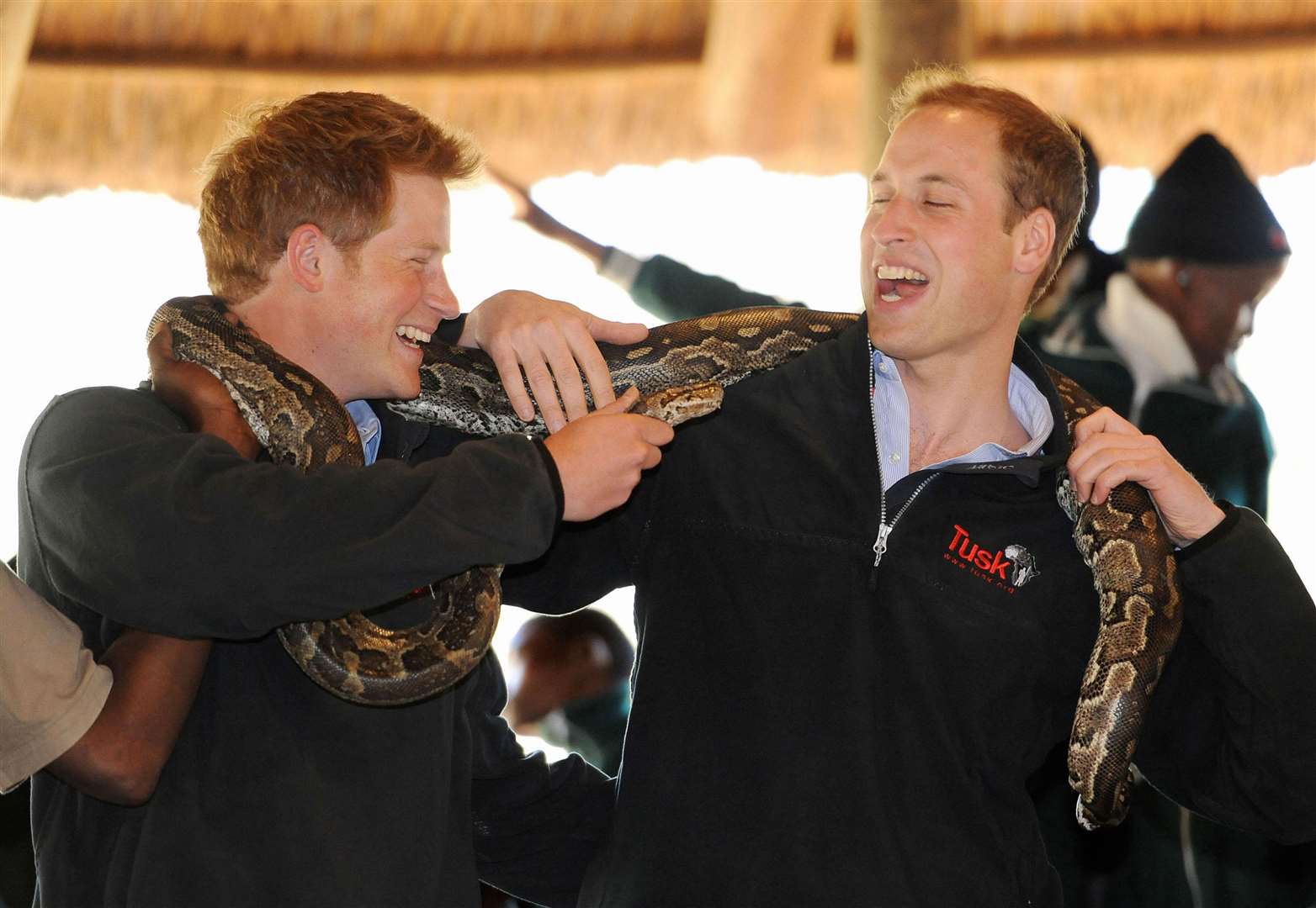 Harry, 25, and William, 27, pose with a rock python during a visit to the Mokolodi Nature Reserve in Gaborone, Botswana (Anthony Devlin/PA)