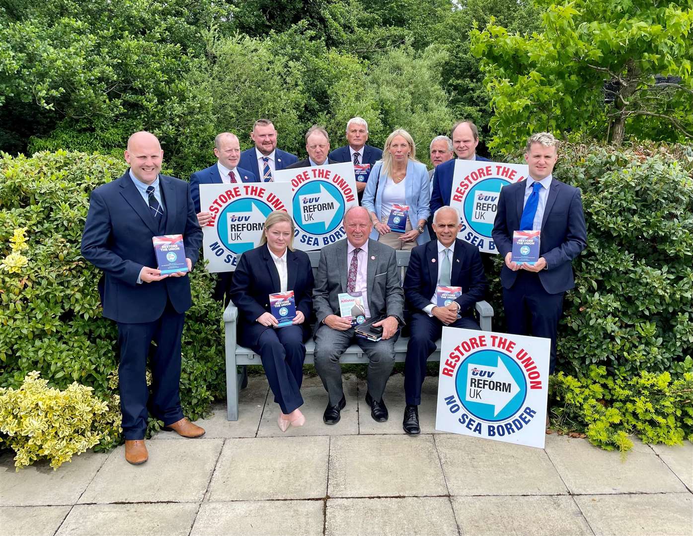 Reform UK deputy leader Ben Habib (on the bench, right) and TUV leader Jim Allister (on the bench centre) with parliamentary election candidates at the TUV manifesto launch at Dunsilly Hotel in Co Antrim (David Young/PA)