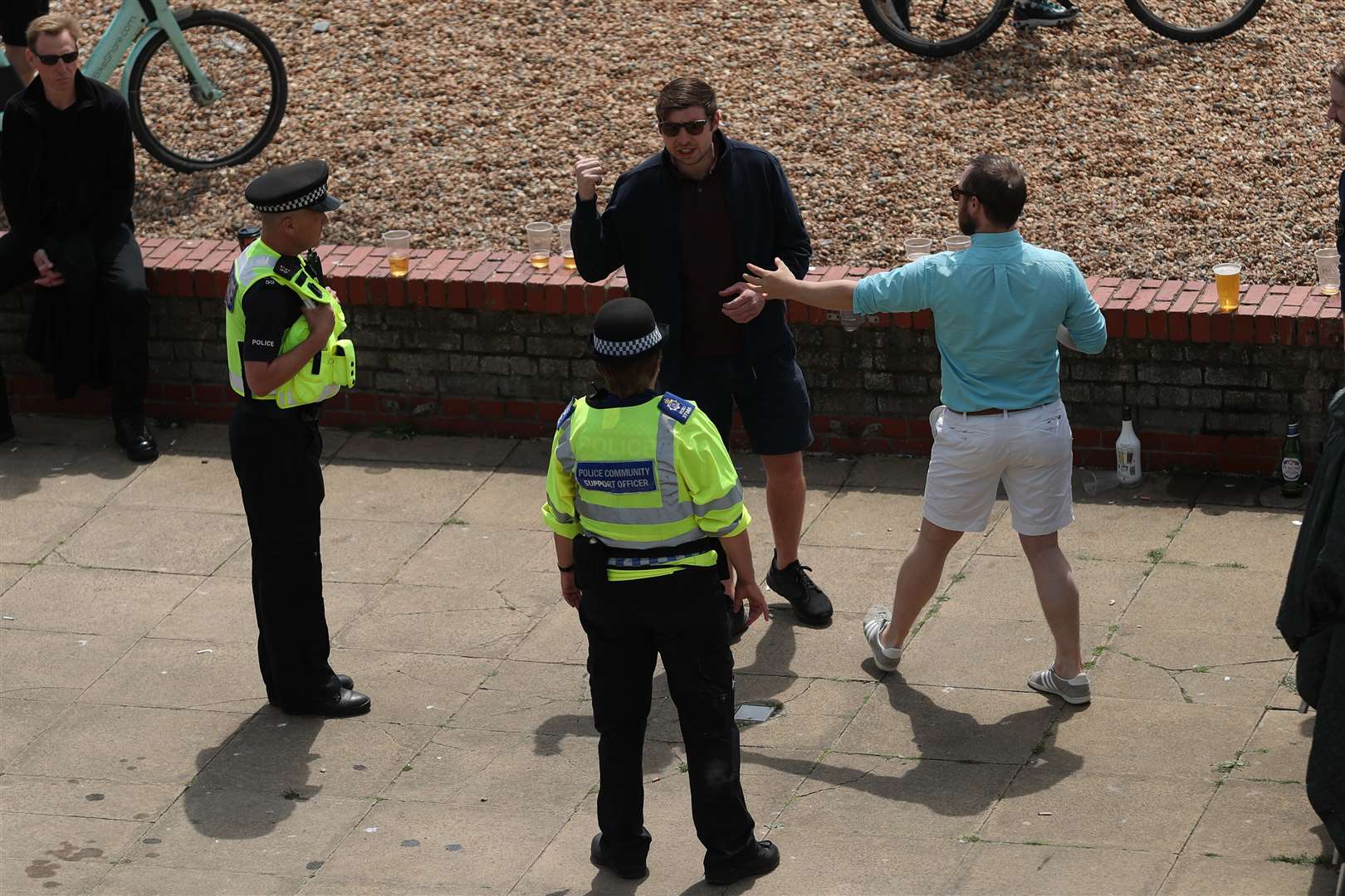 Police talk to people on the sea front (Yui Mok/PA)