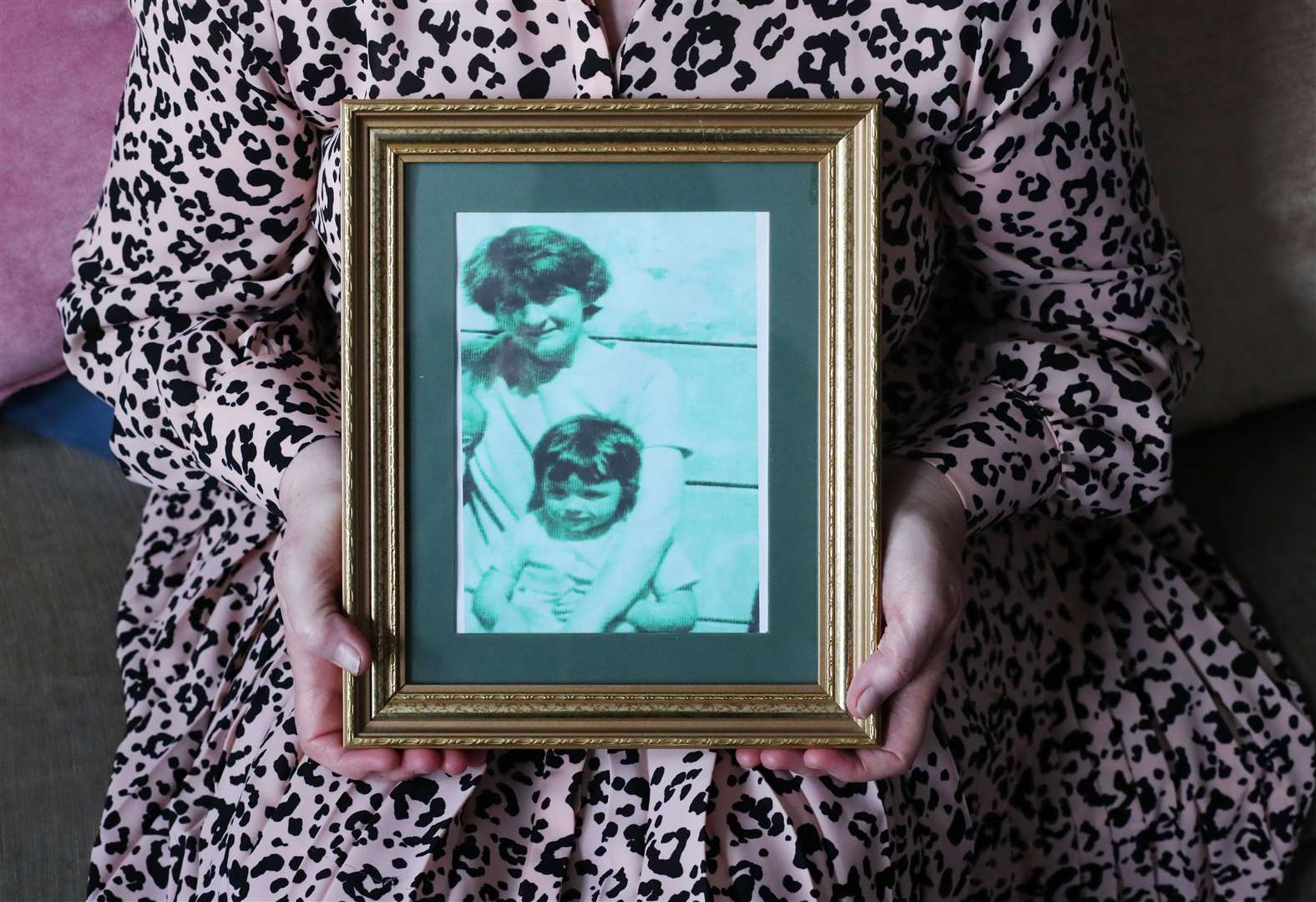 Briege Voyle holds the last picture taken of her mother mother Joan Connolly, holding her two-year-old daughter Irene (Niall Carson/PA)