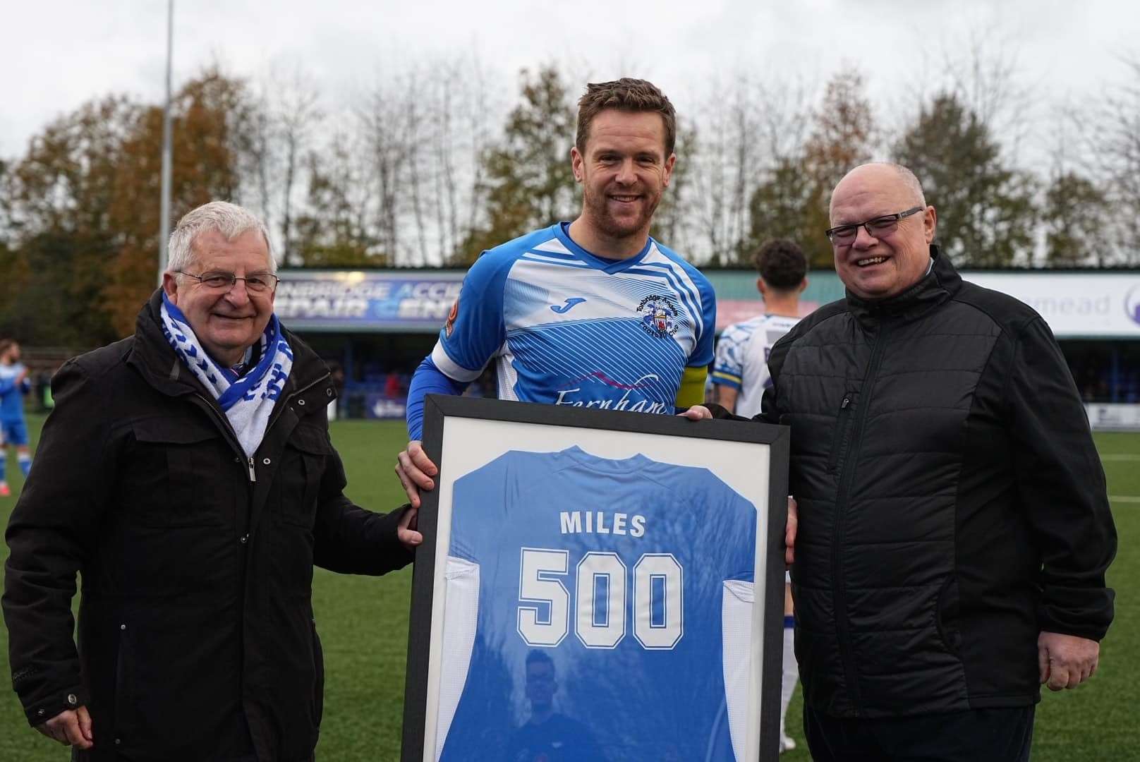 Tonbridge skipper Sonny Miles is presented with a framed shirt marking his 500th appearance by chairman Dave Netherstreet and president Steve Churcher. Picture: Wes Filtness