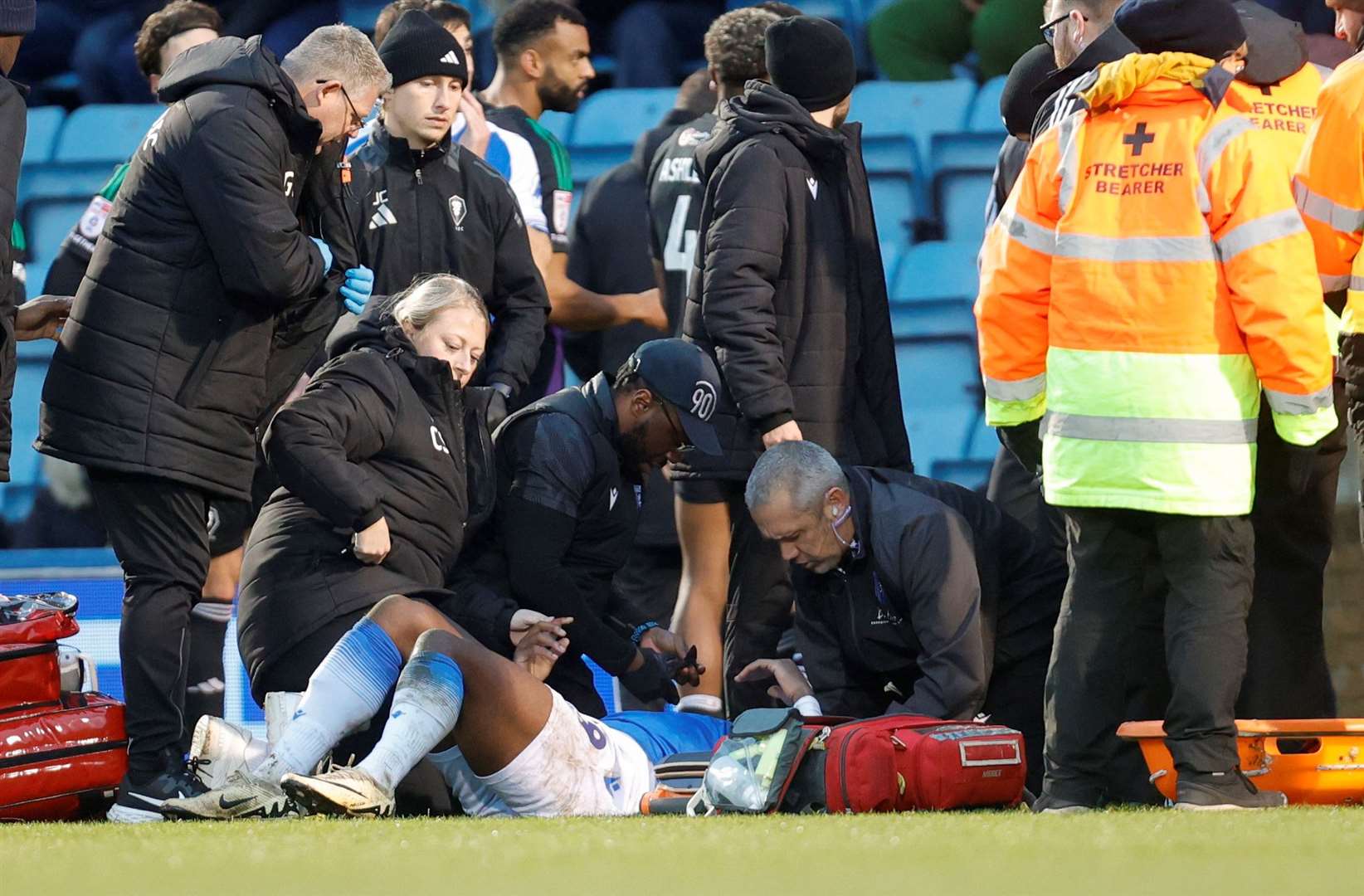 Joe Gbode receives treatment after a blow to the head in Gillingham's game against Salford City at Priestfield Picture: @Julian_KPI