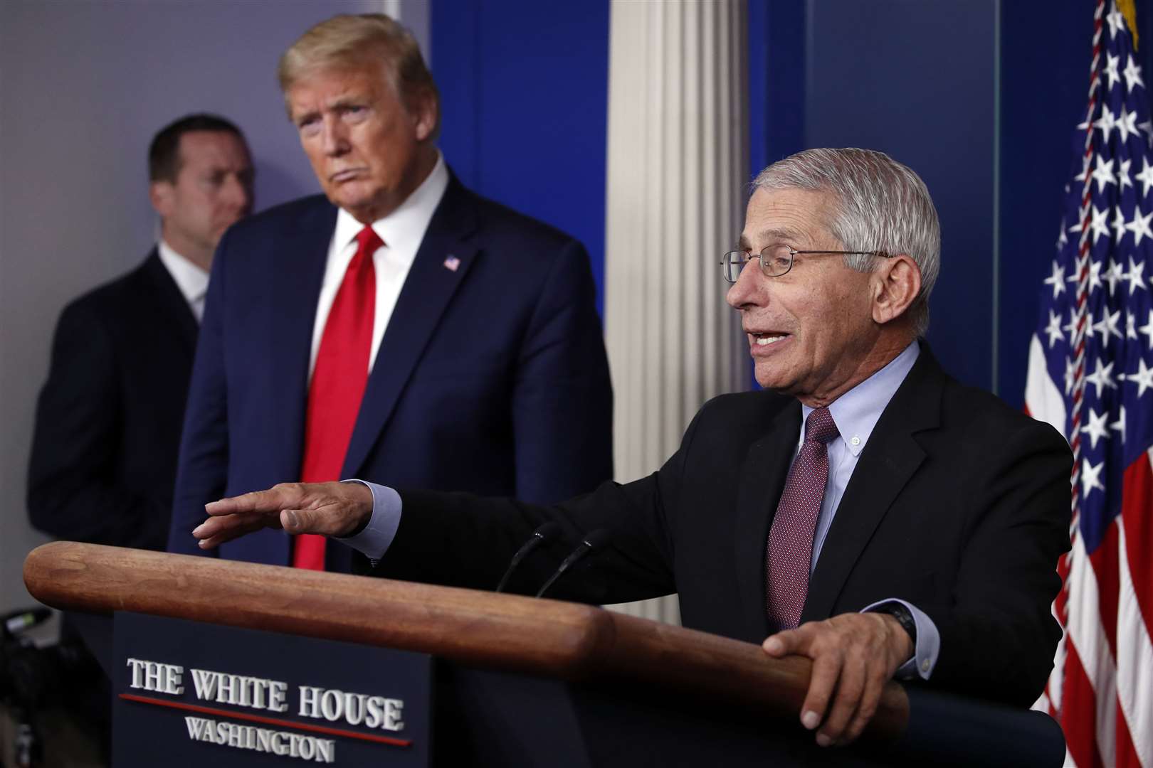 President Donald Trump threatened to fire infectious diseases expert Dr Anthony Fauci (Alex Brandon/AP)