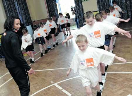 Dame Kelly Holmes keeps an eye on Featherby pupils