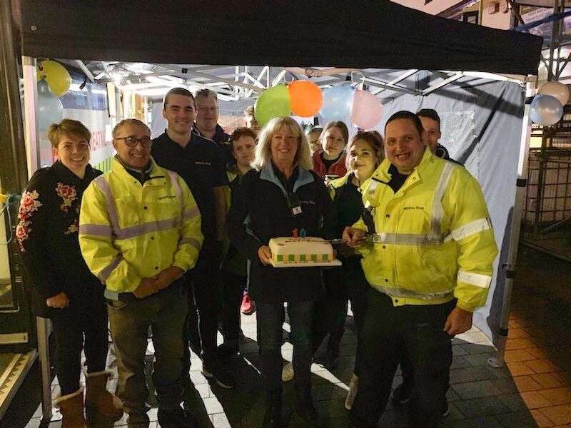 Urban Blue Bus volunteers with the 10th birthday cake outside the support tent (9378689)