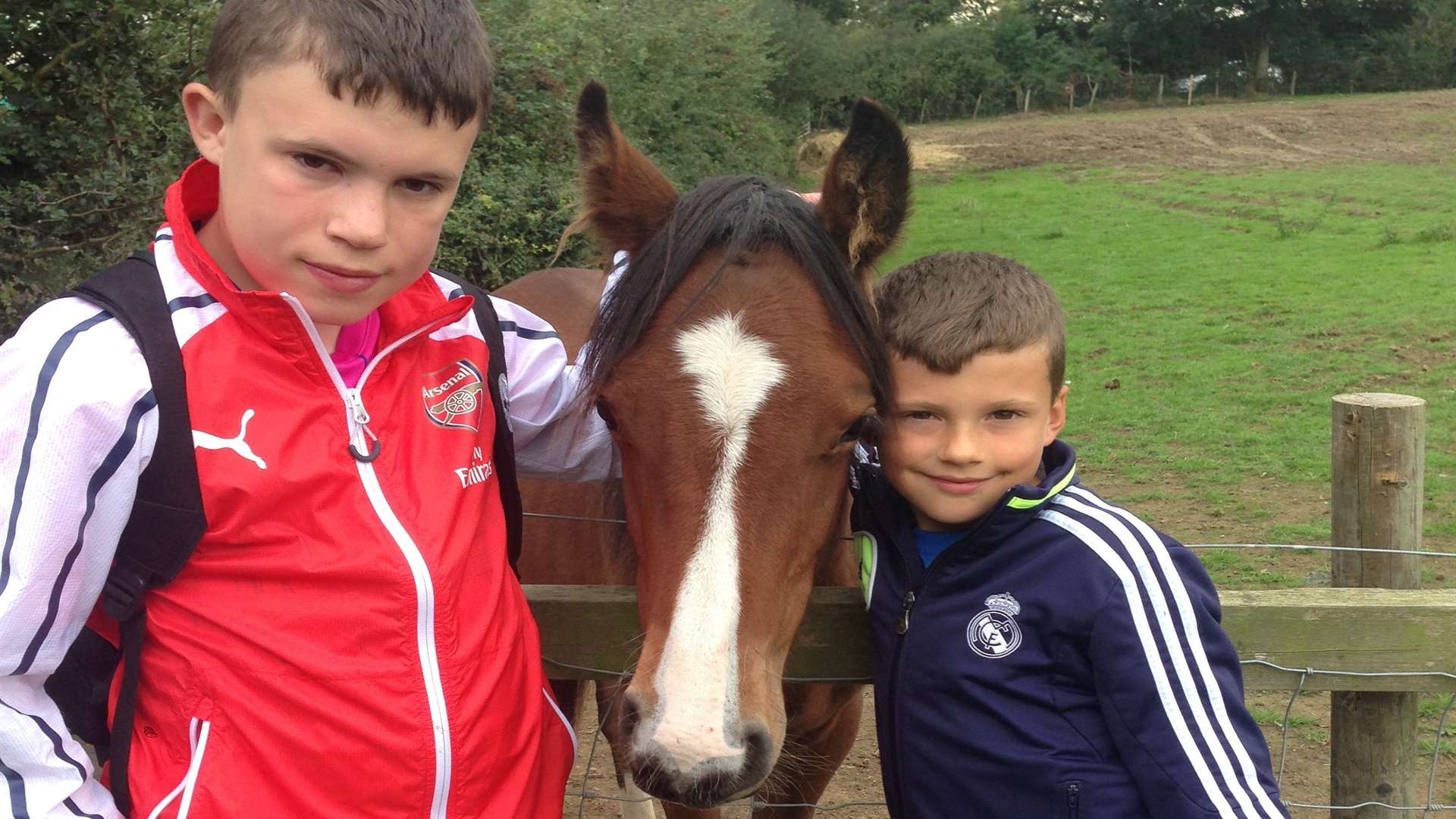 Danny and Kieran Shaw with Todd, a foal rescued by the retreat