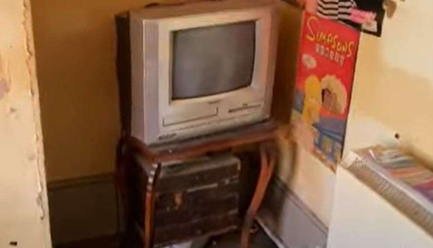 A TV in-built VHS and DVD players along with a Simpsons poster. Picture: Clive Emson / YouTube