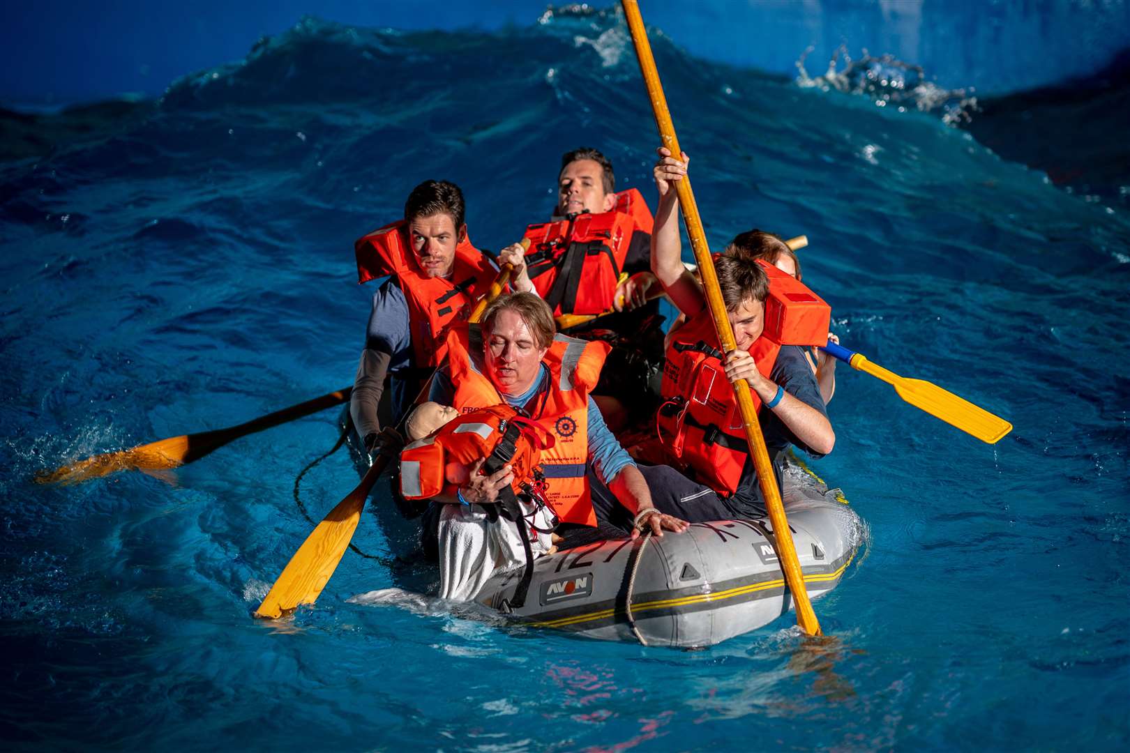 Members of the press take part in a simulation of a migrant channel crossing in a tiny dinghy with a wave machine running in a special training pool at the RNLI’s sea survival facility in Poole, Dorset (Ben Birchall/PA)