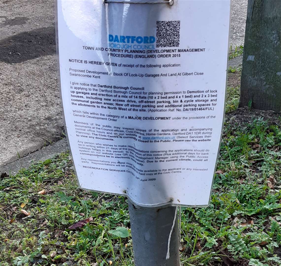 A sign indicating the council's plans to build new social homes in Gilbert Close