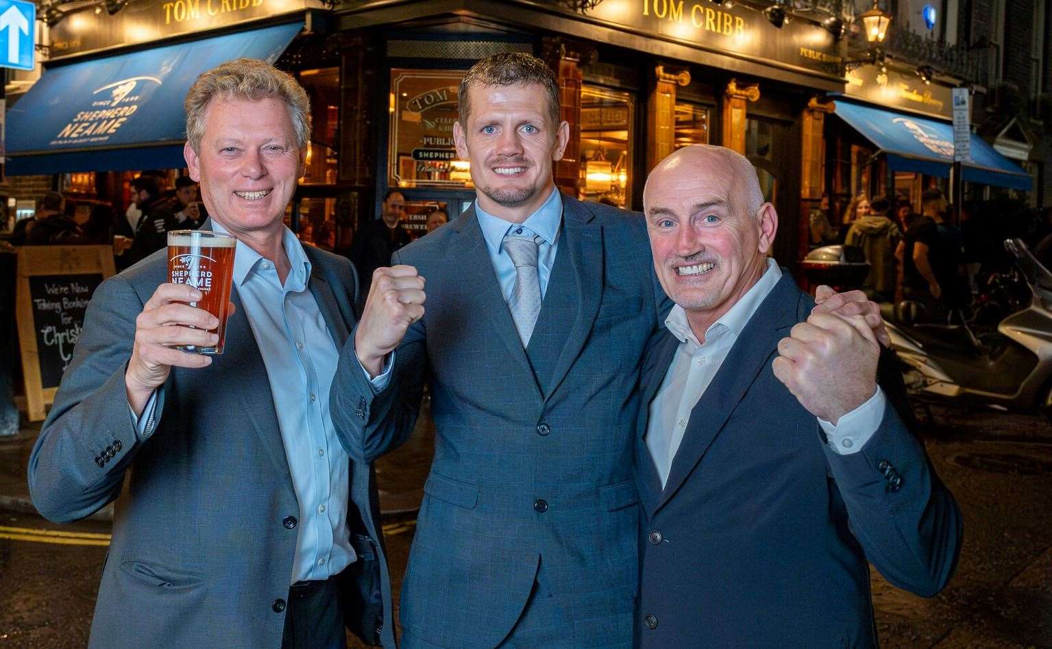 Shepherd Neame chief executive Jonathan Neame with Faversham boxer Alex Branson-Cole and former world champion Barry McGuigan outside the Tom Cribb pub. Picture: Shepherd Neame