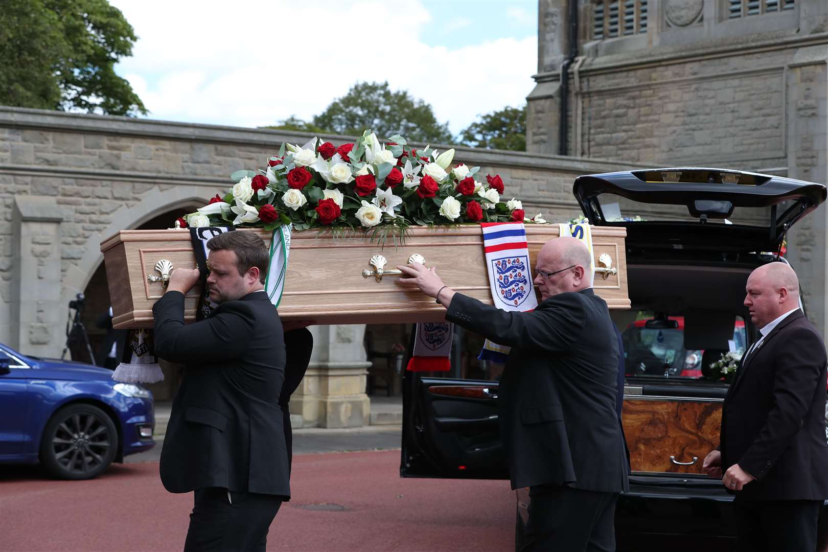 Football scarves were draped on his coffin (Peter Byrne/PA)