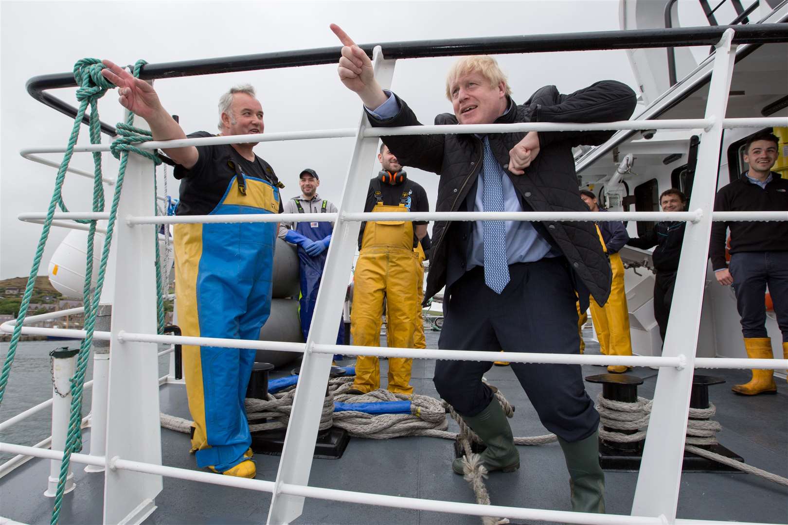 Prime Minister Boris Johnson speaks to members of the crew on the Carvela at Stromness Harbour (Robert Perry/PA)