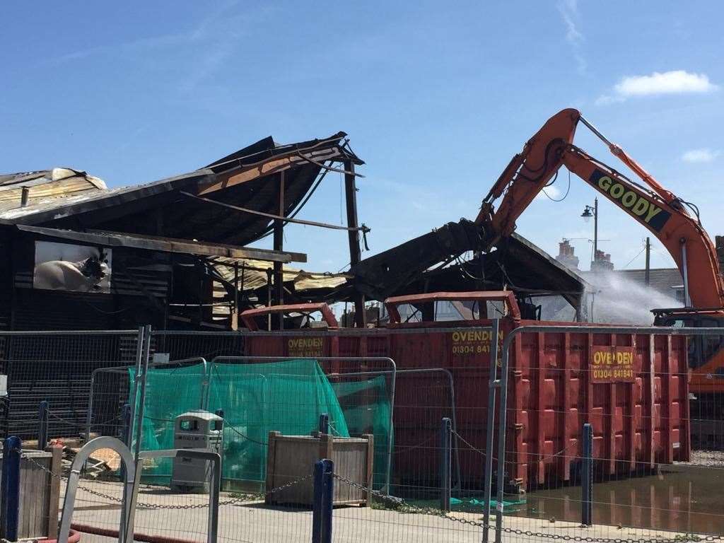 Demolition of fire-ravaged cockle shed under way at Whitstable Harbour on Friday afternoon